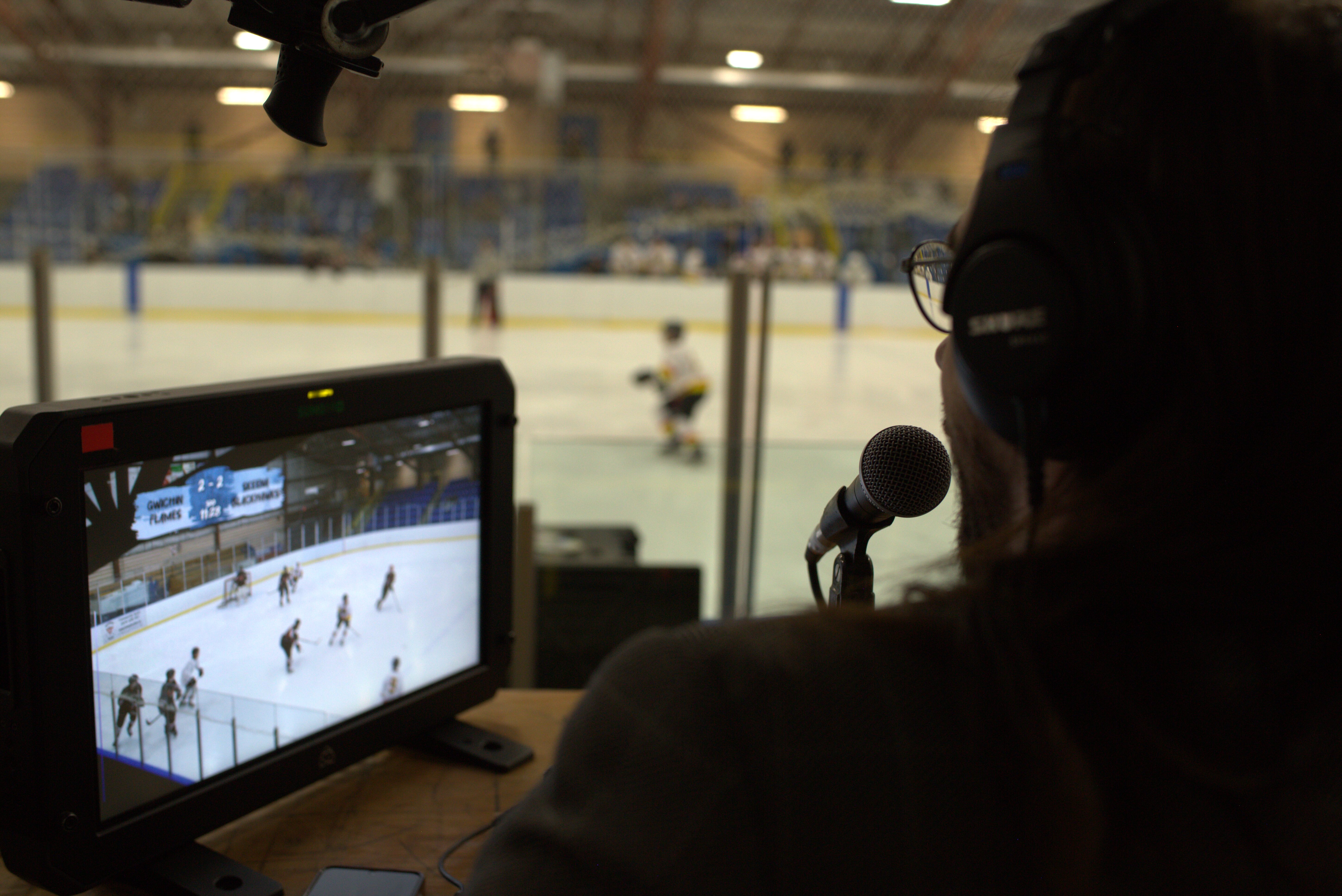 Commentators in a live sports broadcast booth